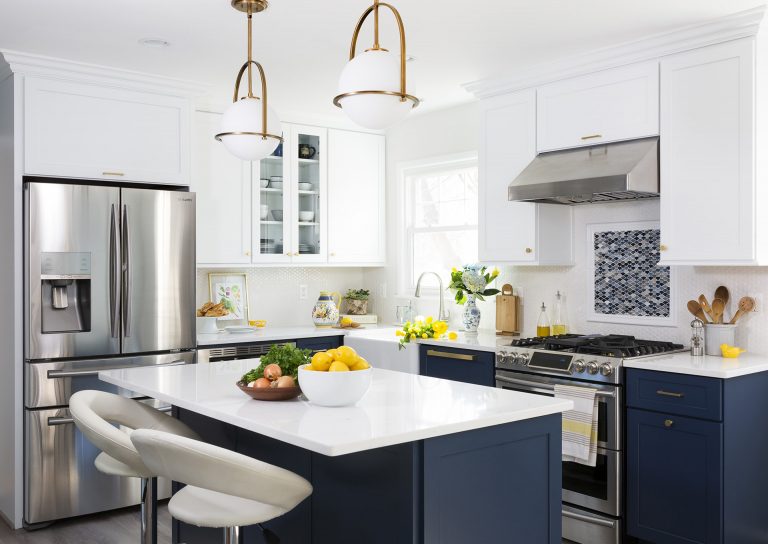 navy white and gold kitchen center island with seating and pendant lighting