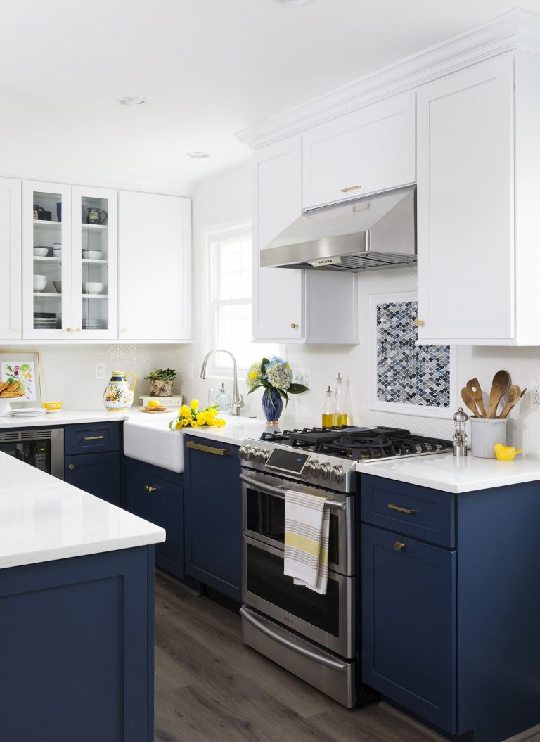 farmhouse style kitchen navy bottom cabinetry white upper cabinetry stainless steel appliances