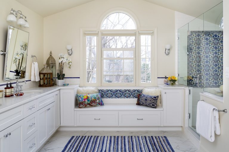bathroom with large bay window and built in window seat white with blue accents