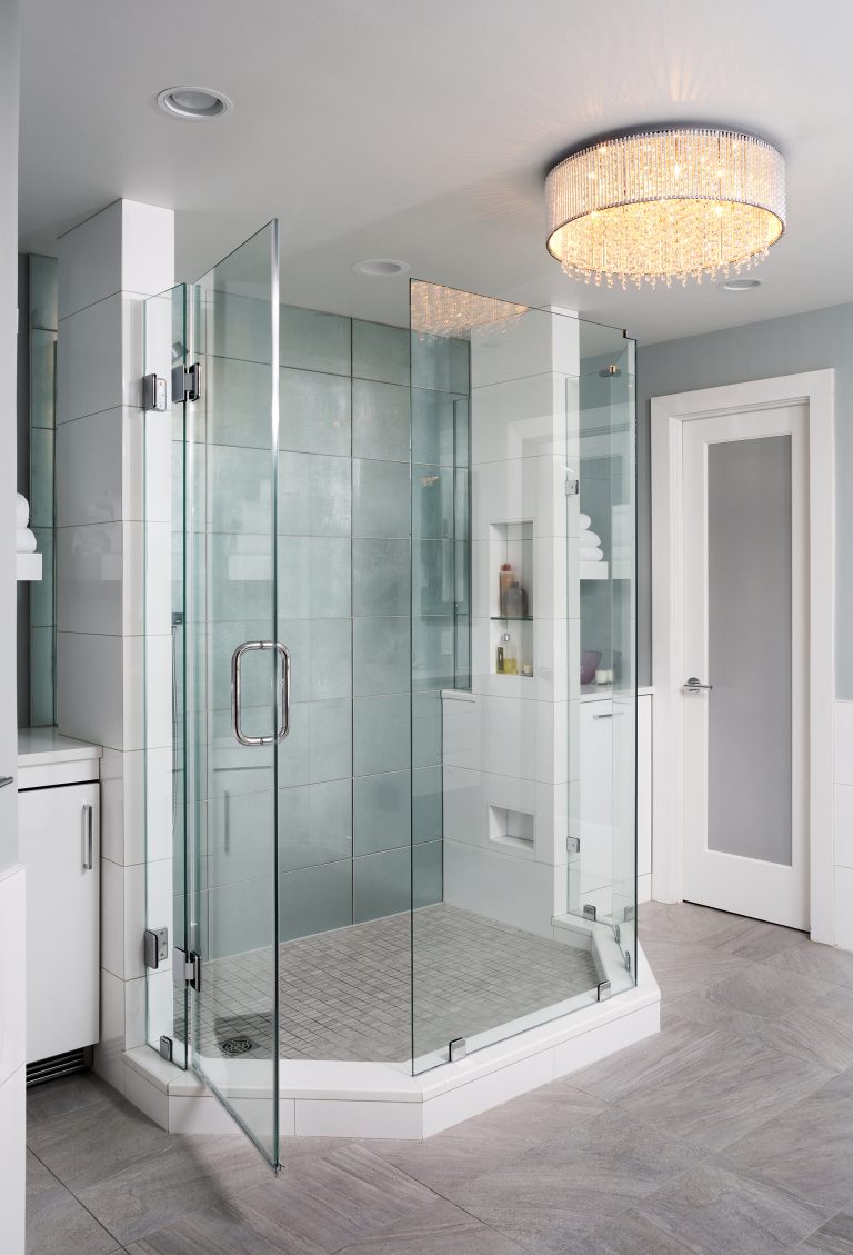 gray and blue bathroom separate shower stall with glass door and mirrored tiles