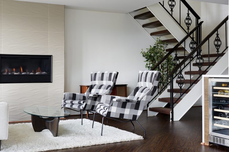 modern living room renovation textured fireplace open stairs black and white