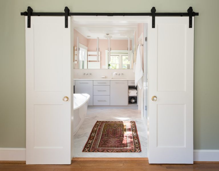 double sliding barn doors open to bathroom