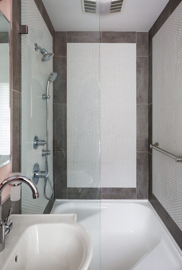 white shower tile with brown border