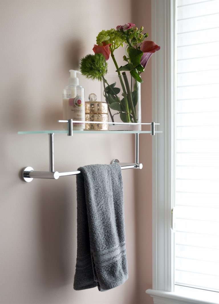 neutral toned pink walls and chrome towel bar