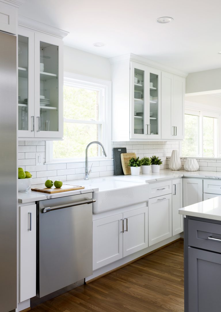 bright kitchen white and gray glass door upper cabinetry porcelain apron sink wood floors