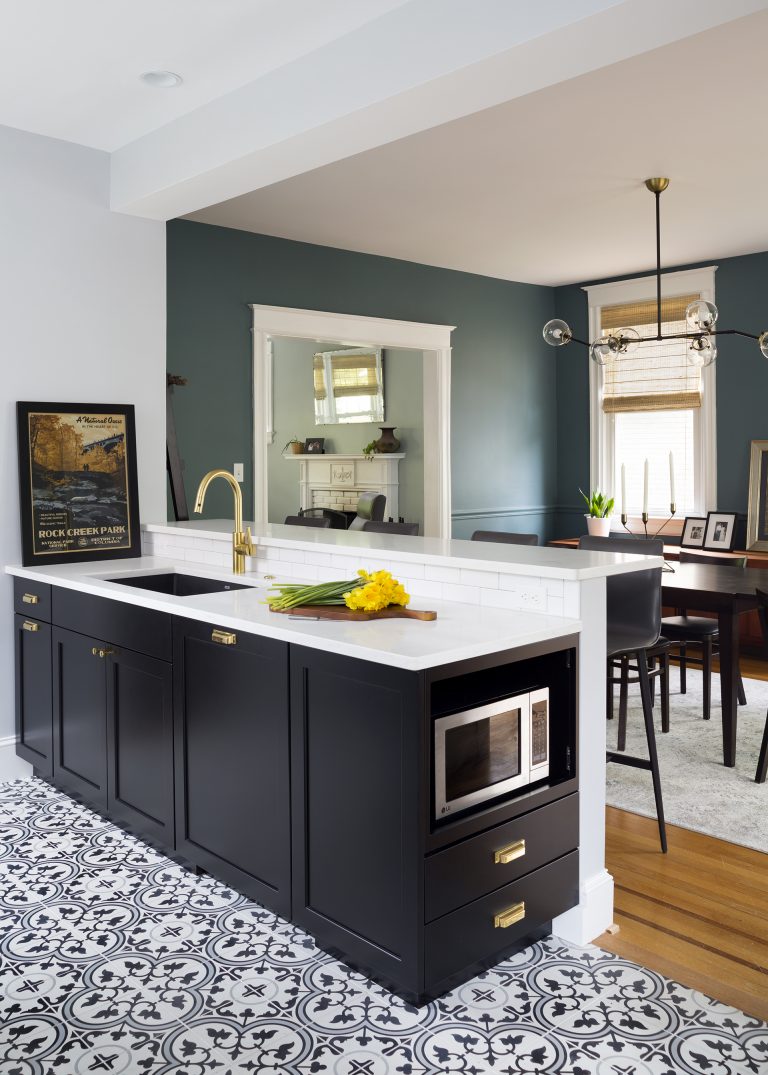 peninsula with seating opens kitchen to rest of home black and white patterned tile floors