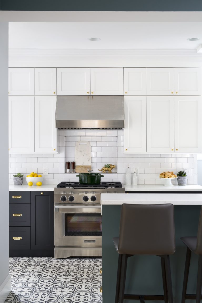 bright kitchen with patterned floor tile black and white cabinetry peninsula with seating stainless steel appliances