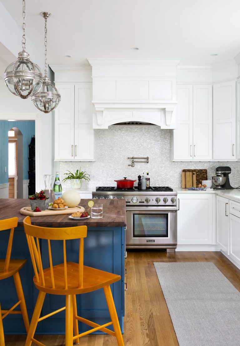kitchen with white outer cabinetry navy blue island cabinetry