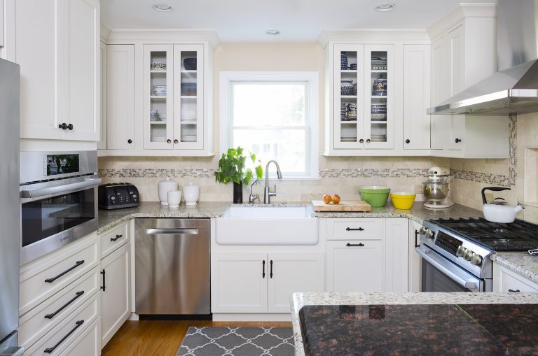 beige and white kitchen porcelain apron sink glass door upper cabinets wood floors