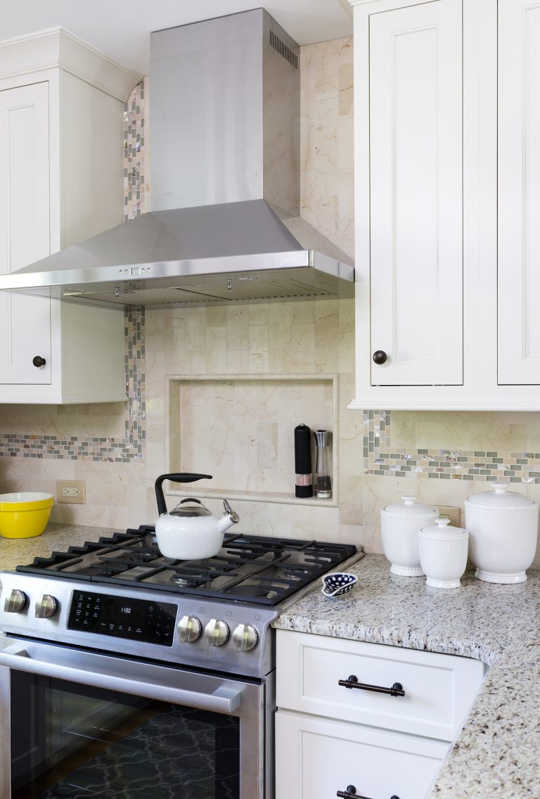 stainless steel gas range and hood with nook built into backsplash