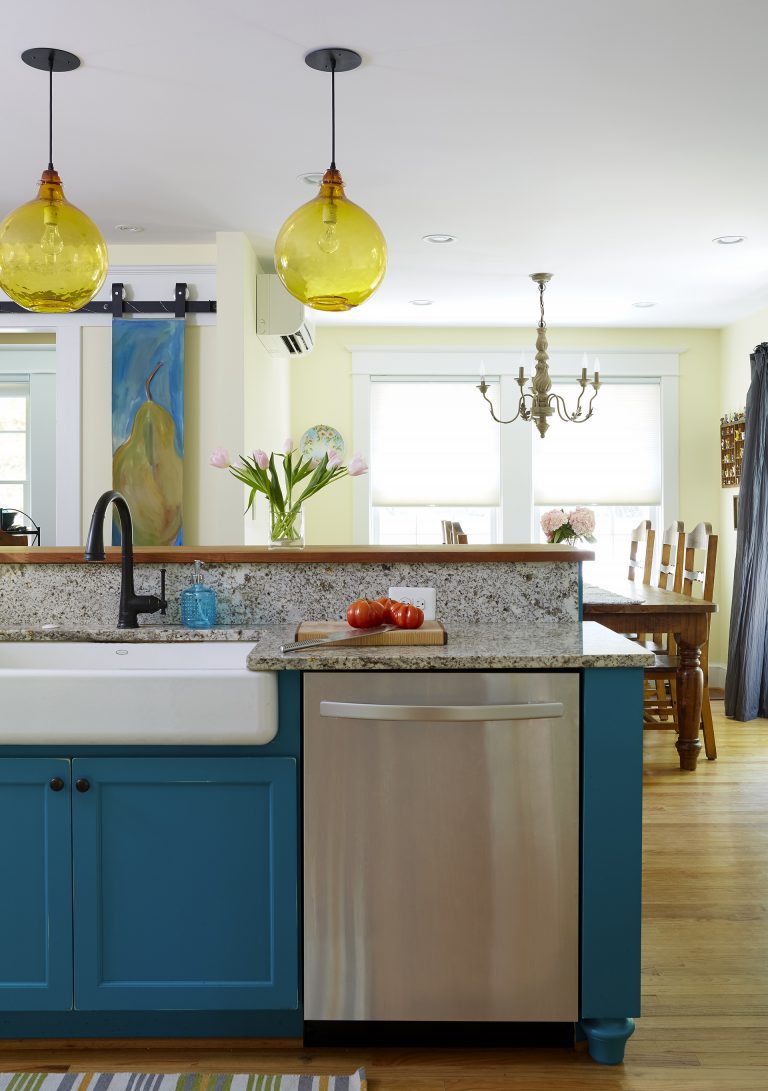 teal island in kitchen with stainless steel appliances