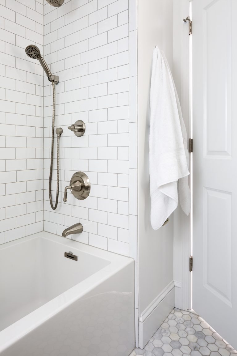 renovated bathroom traditional style all white design subway tile in shower