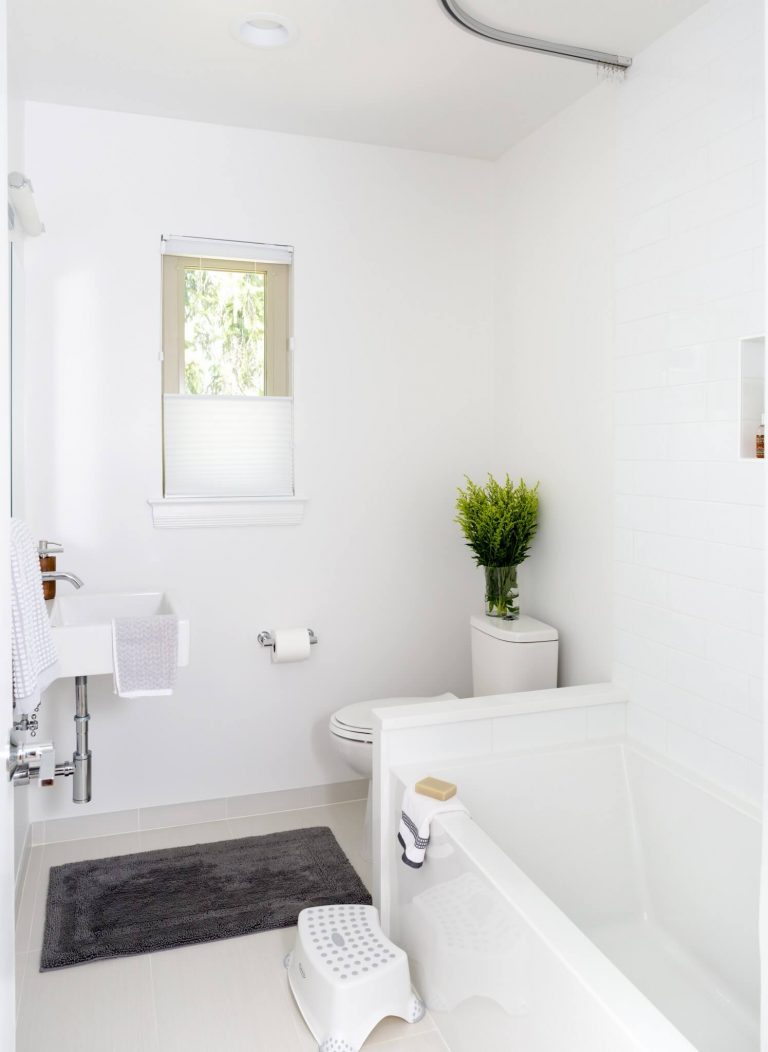 white bathroom separate tub sink with exposed pipes