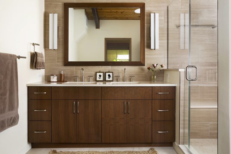 sleek bathroom brown and neutral color palette double sink vanity separate shower stall with glass door