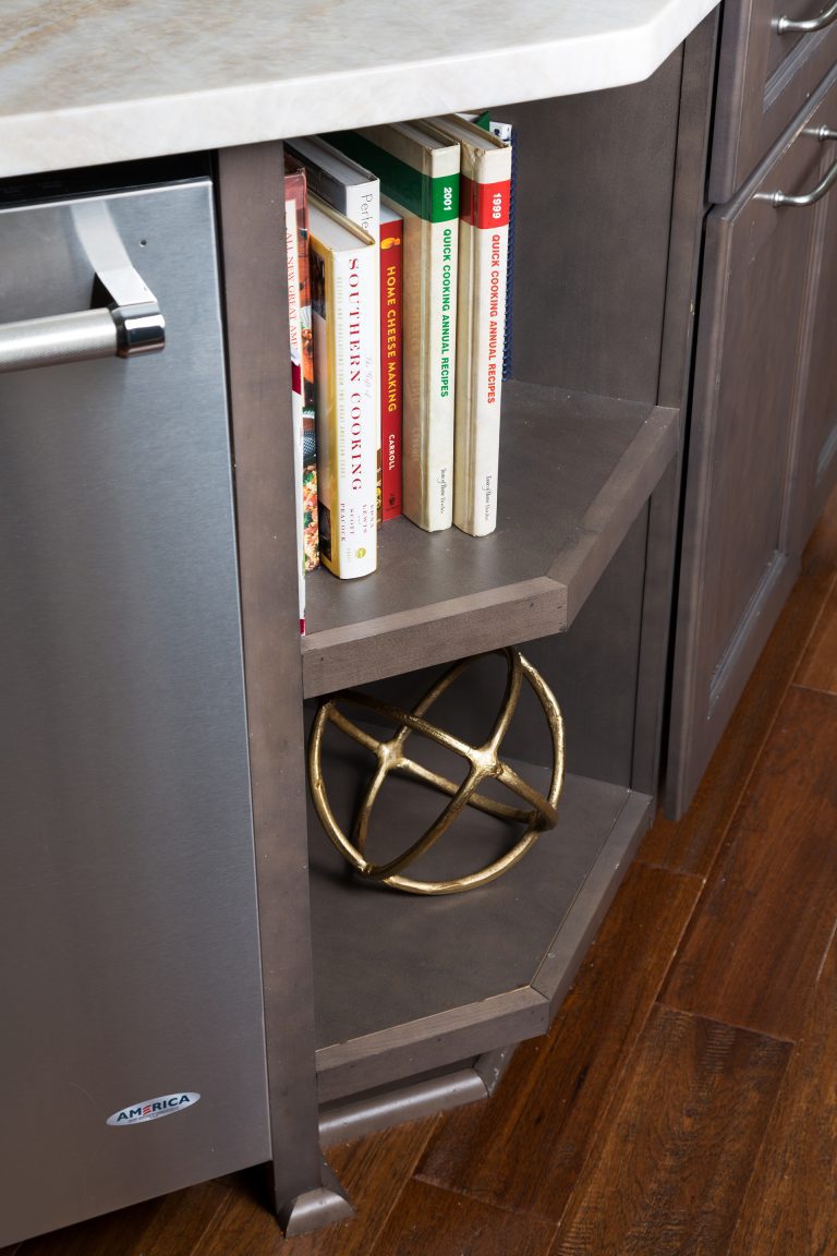 open shelf storage in corner of island cabinetry