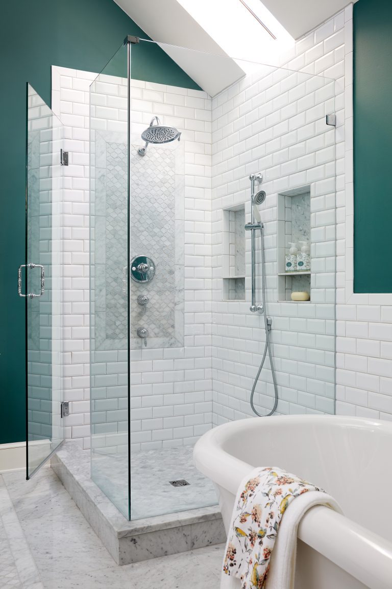 separate shower and bathtub white subway tiles with tile detail in shower skylight and nooks in shower wall