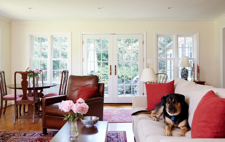 french doors in bright living area leading out to backyard