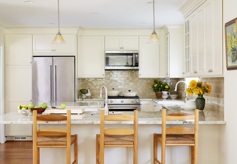 classic kitchen neutral color palette peninsula with seating pendant lighting