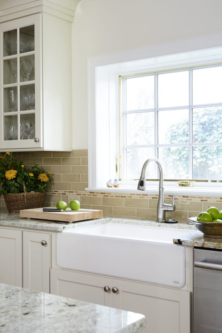 classic kitchen neutral color tones large window over farmhouse sink upper cabinets with glass doors