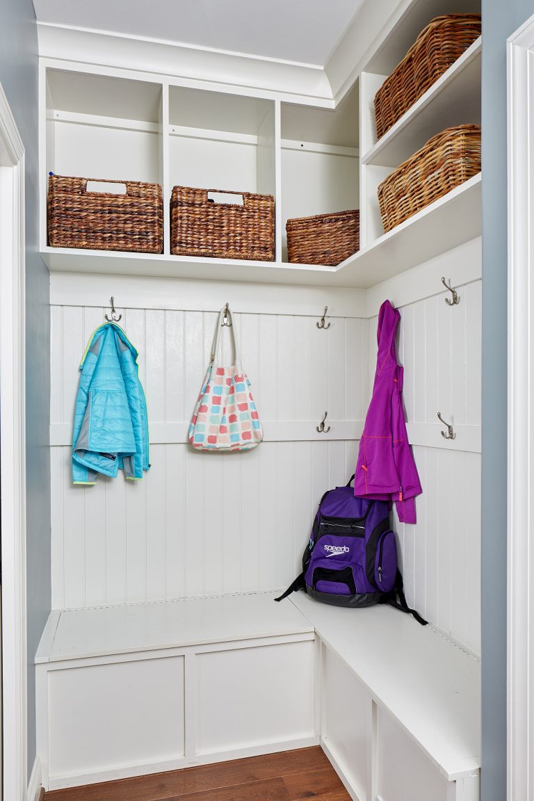 mudroom area with wood floors hooks and cubby storage