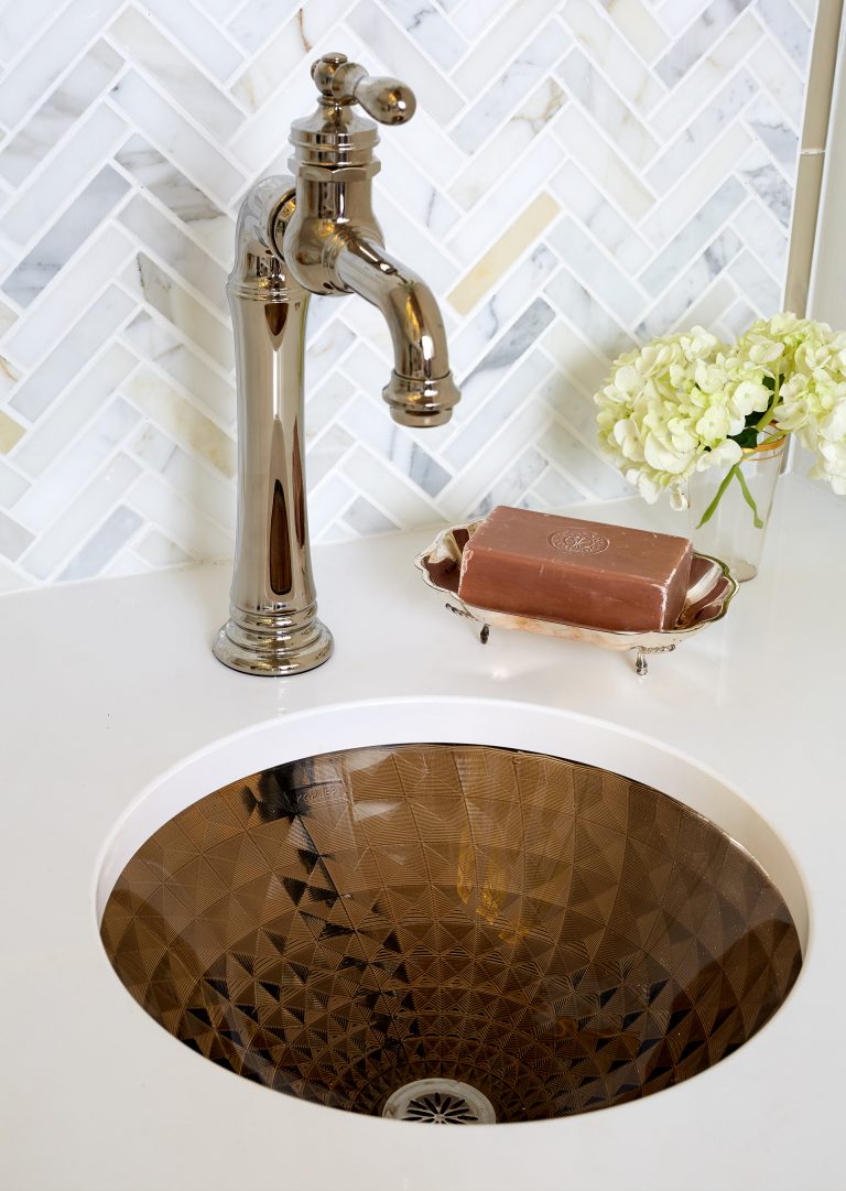 bronze mini kitchen sink with bronze fixtures chevron tile backsplash
