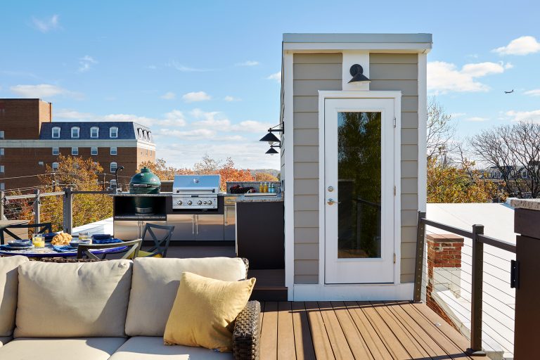 glass door leads to rooftop living area