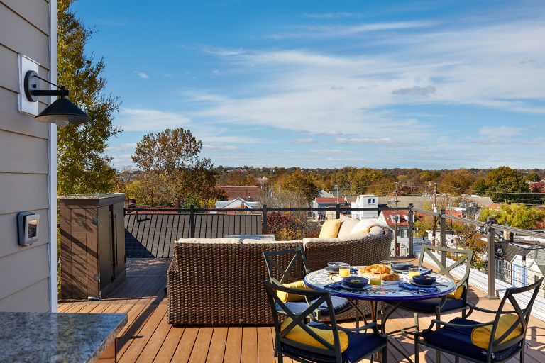 rooftop living area seating area and dining area outdoor sconce lighting