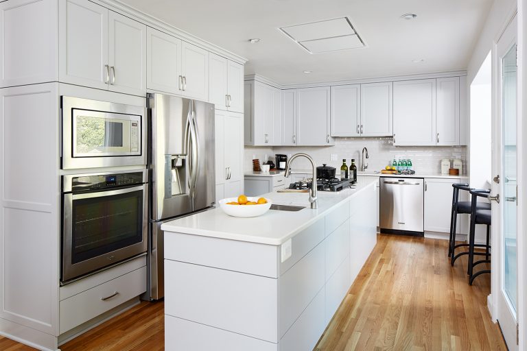 kitchen with white cabinetry and center island stainless steel appliances wall oven