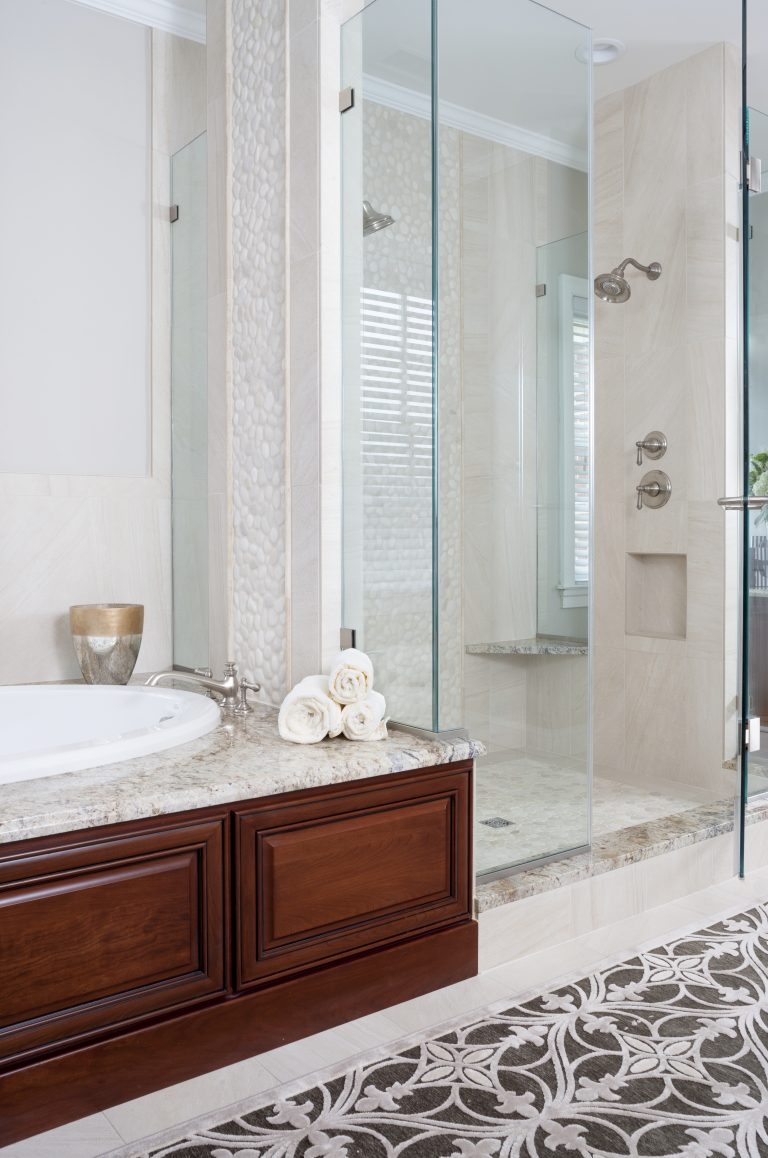 wood paneled bathtub separate shower stall with glass wall built in bench and wall nook