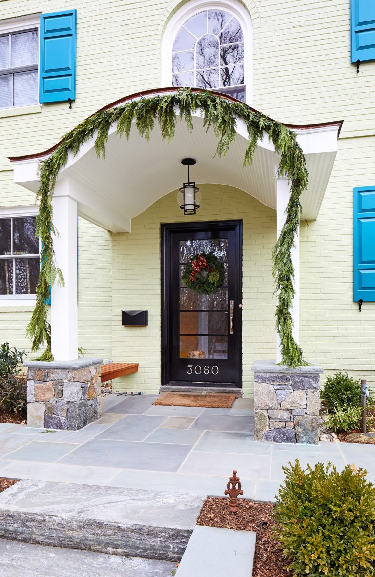 front entryway covered porch flagstone floors arched window outdoor lighting