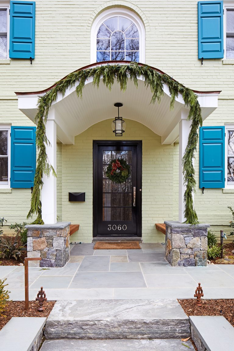 front entryway covered porch flagstone floors arched window outdoor lighting