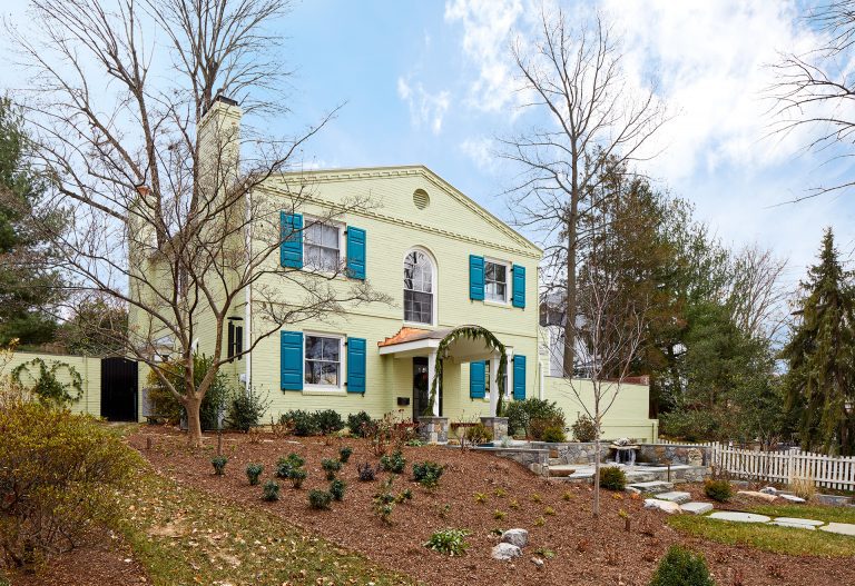 front porch renovation on DC home blue shutters stone walkway