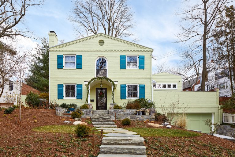 front porch renovation on DC home blue shutters stone walkway