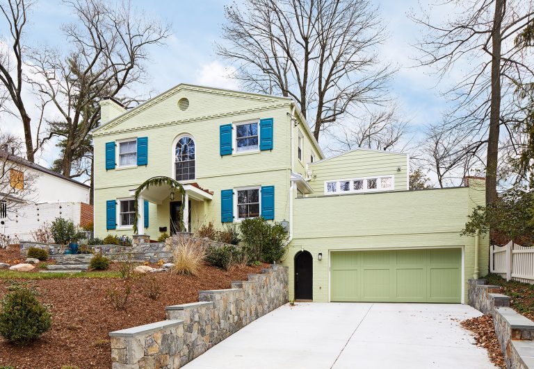 front porch renovation on DC home blue shutters stone walkway green garage doors