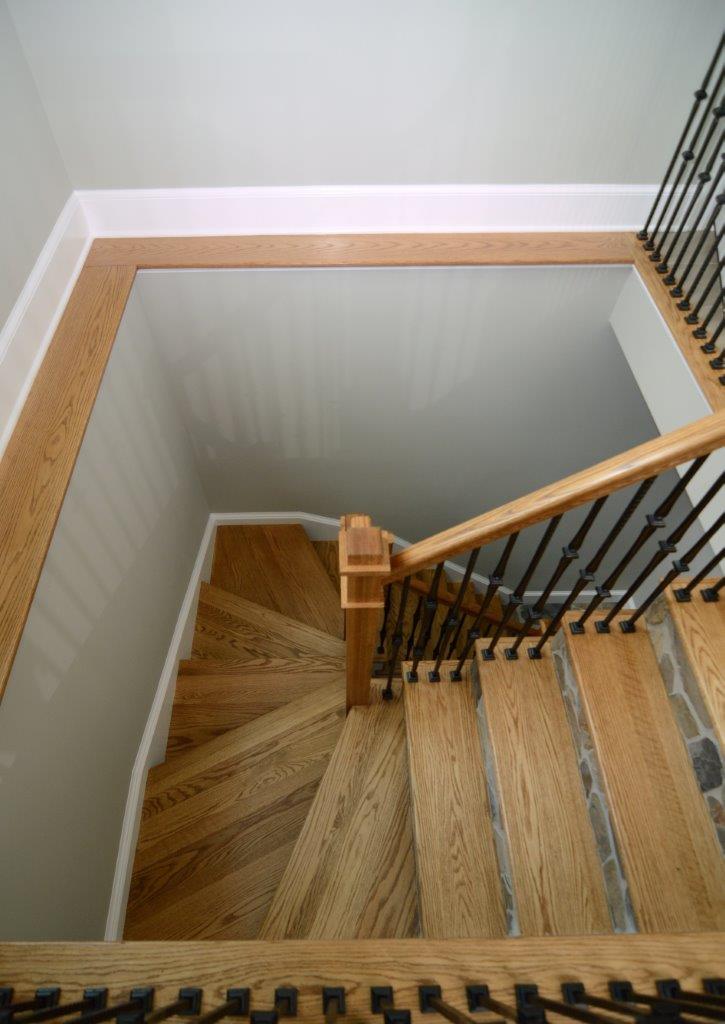 birds eye view of staircase with light wood banister