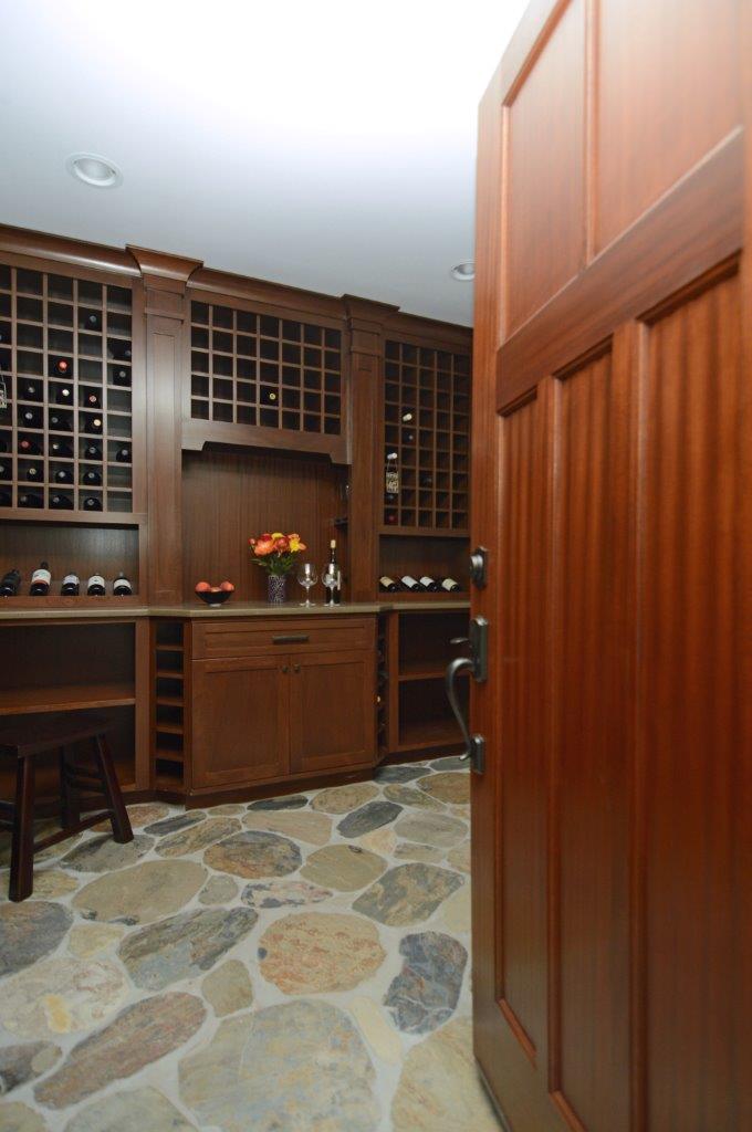 wine cellar with stone floors dark cabinetry plenty of wine storage recessed lighting