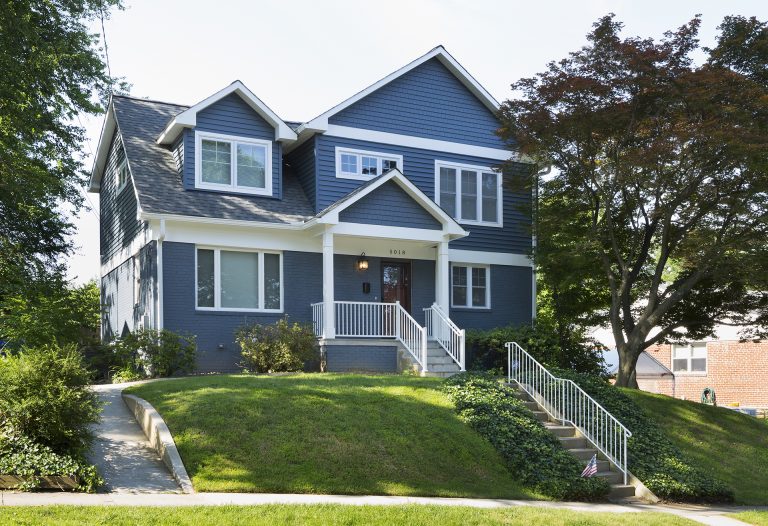 blue maryland house on hill with stone stairs and covered front porch