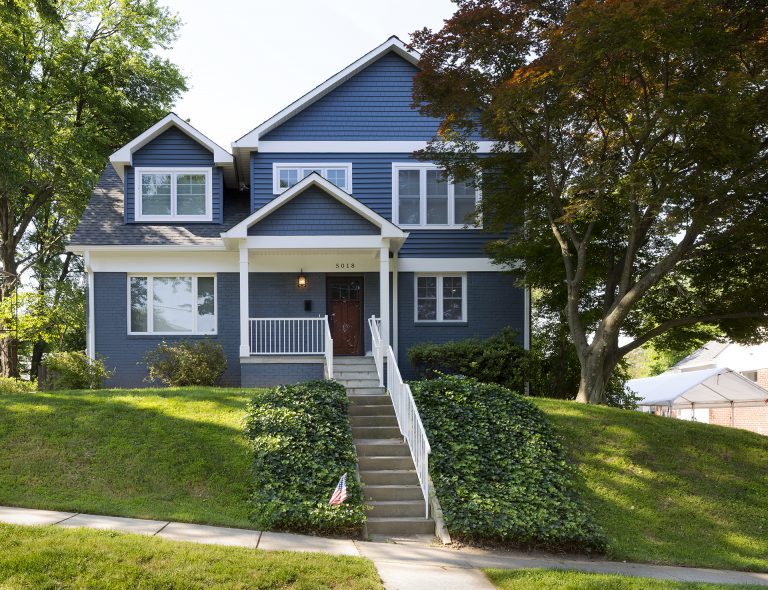 blue maryland house on hill with stone stairs and covered front porch