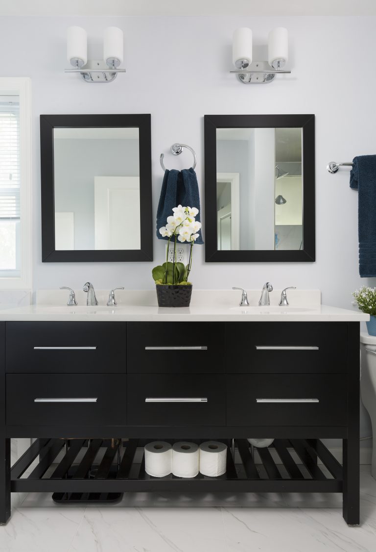 black bathroom vanity with double sinks and open shelving underneath white walls sconce lighting chrome fixtures