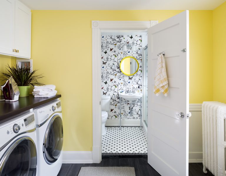 laundry room with yellow walls leads into bathroom