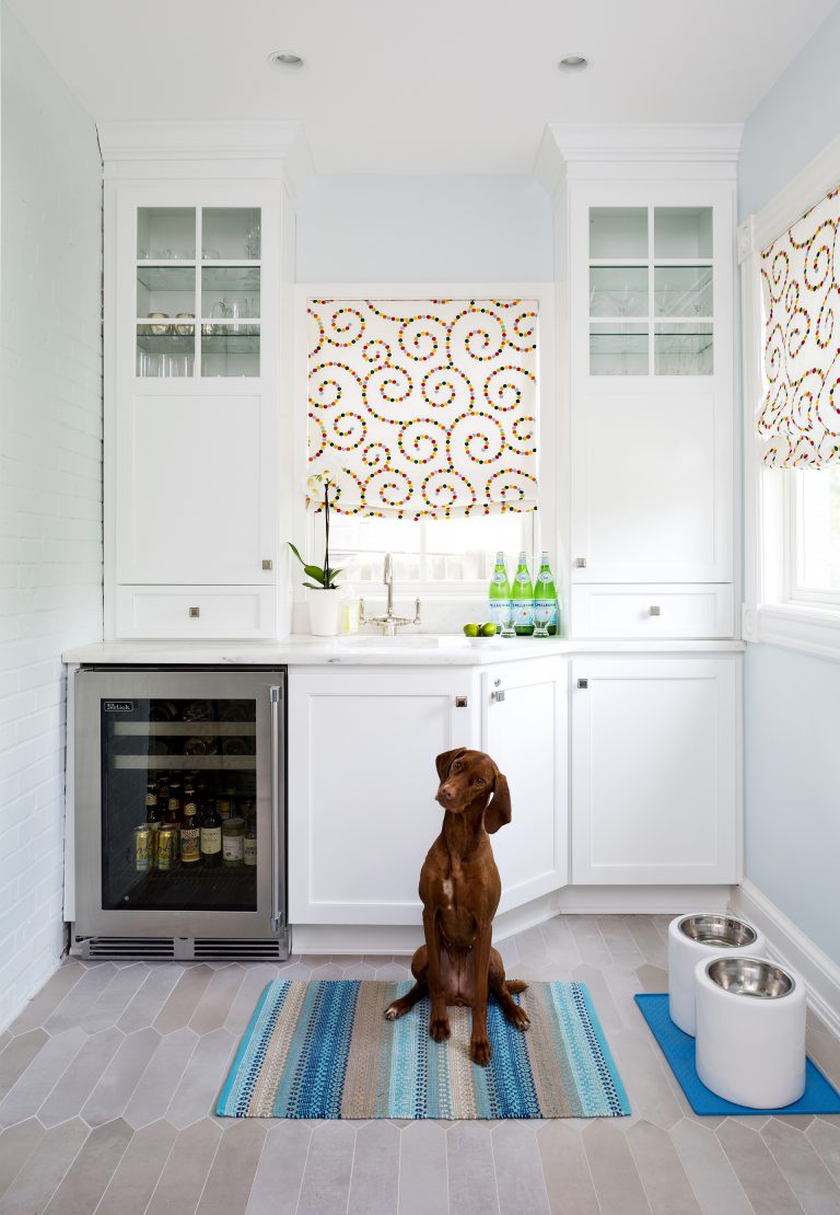 minibar area with white cabinetry with glass door uppers gray floors and beverage refrigerator