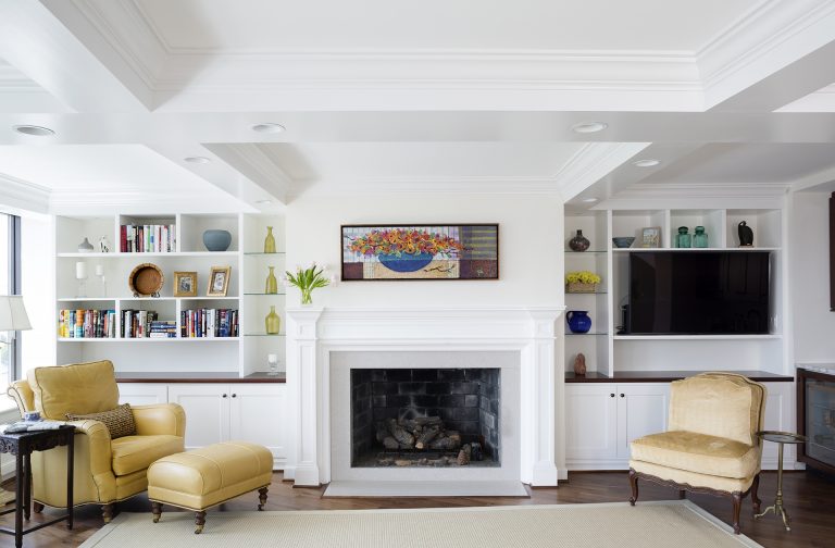 bright living room with wood floors coffered ceiling fireplace built in bookcases recessed lighting