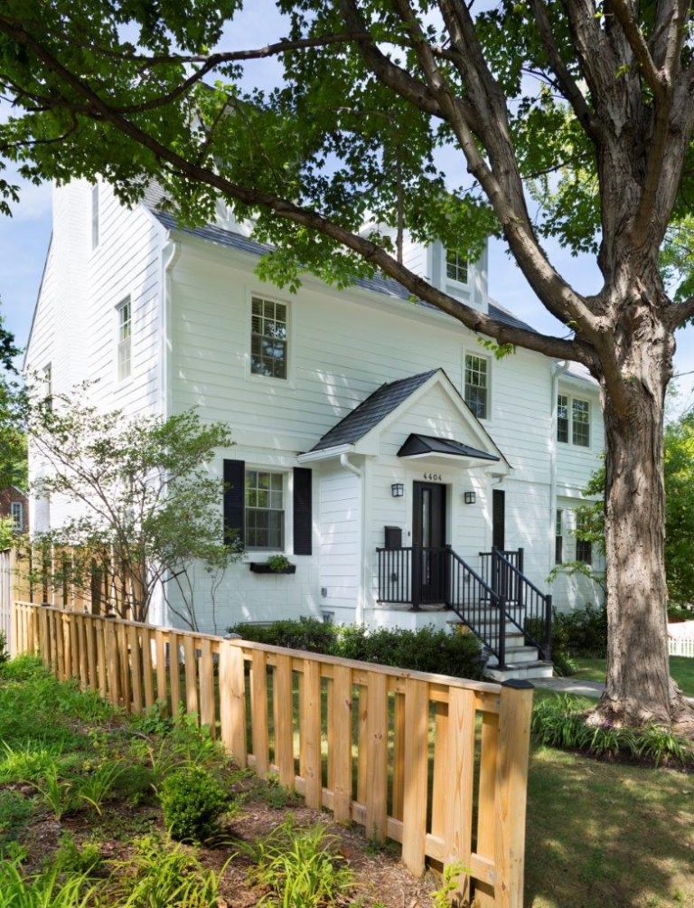 white DC home with portico and wooden fence