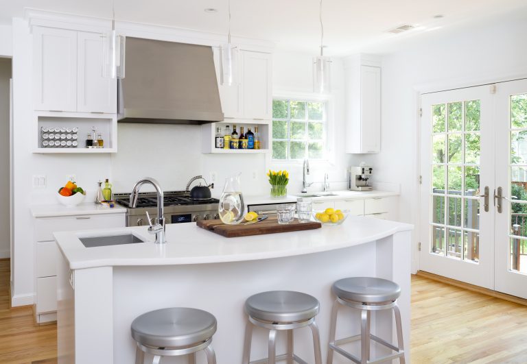bright white kitchen with wood floors glass french doors island with seating stainless steel appliances