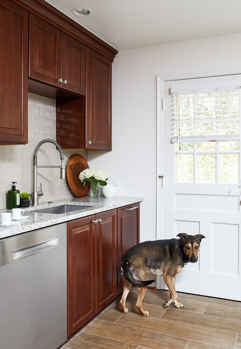 traditional style kitchen dark stained wood cabinetry stainless steel appliances