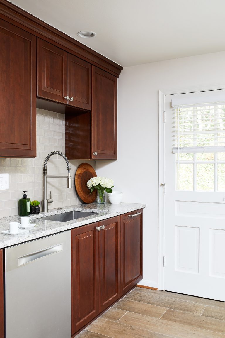 traditional style kitchen dark stained wood cabinetry stainless steel appliances