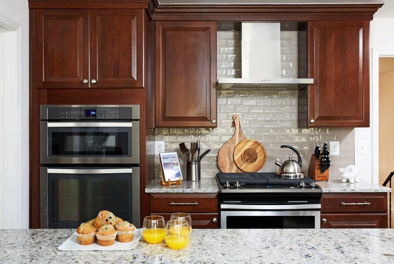 view over kitchen peninsula of range and wall oven