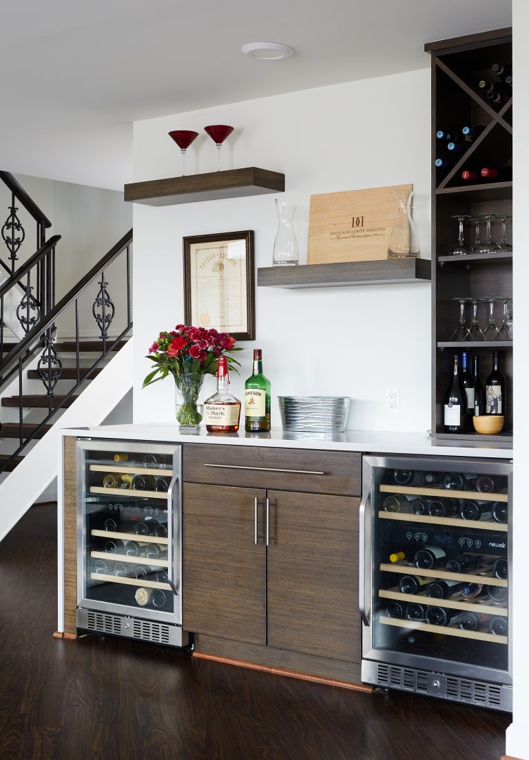minibar area with dual beverage refrigerators wine storage and floating shelves
