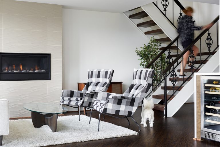 living room with textured fireplace surround and open staircase