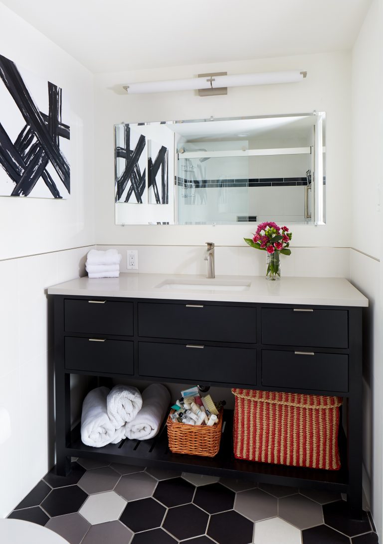bathroom with black gray and white color scheme vanity with open shelving underneath
